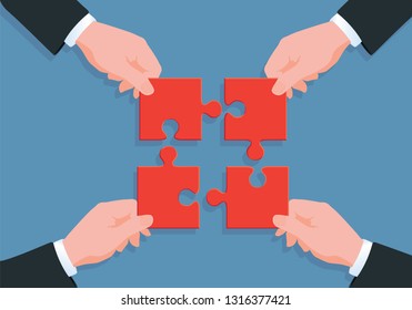 Concept of working collaboratively in a company, where each partner brings his stone to the building, to achieve a common project. Illustrated here by four hands holding a puzzle piece.