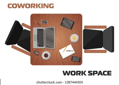 Concept of workplaces in coworking space for two people. View from above. Place for online work or online learning. Laptop, tablet, gadgets, writing materials lie on a wooden table. Two chairs.