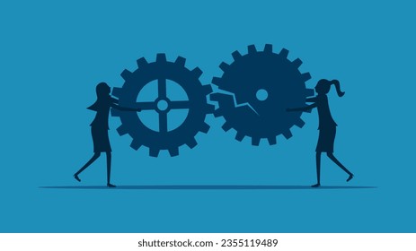 Concepts hinder communication or cooperation. Two businesswomen holding a broken gear mechanism