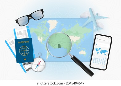 Conceptual illustration of a trip to Ghana with travel gear. World map with compass, passport, tickets, cell phone, plane and glass.