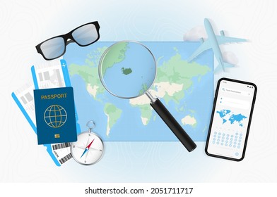 Conceptual illustration of a trip to Iceland with travel gear. World map with compass, passport, tickets, cell phone, plane and glass.