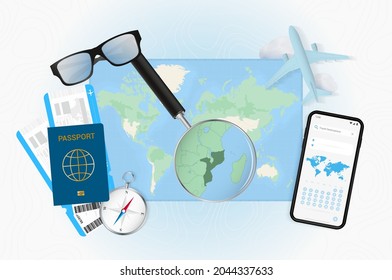 Conceptual illustration of a trip to Mozambique with travel gear. World map with compass, passport, tickets, cell phone, plane and glass.