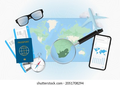 Conceptual illustration of a trip to South Africa with travel gear. World map with compass, passport, tickets, cell phone, plane and glass.