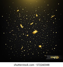 Confetti isolated on dark background with light. Golden confetti. Confetti with motion effect.