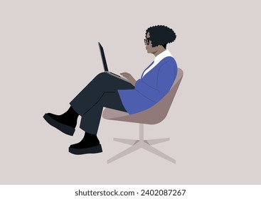 The confident African woman typing diligently on her laptop, comfortably seated in a chair