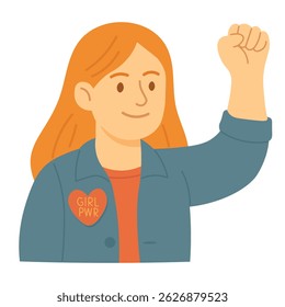 Confident girl raising her fist with a heart-shaped Girl Power badge on her jacket.