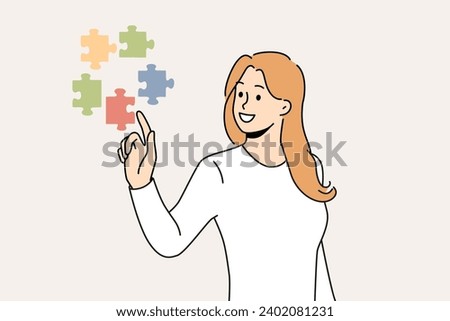 Confident woman doing brainstorming touching with finger flying puzzles symbolizing business task that requires solution. Girl with smile solves complex business problem on behalf of manager.