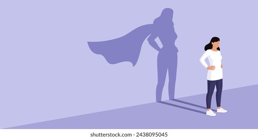 Confident woman standing and looking away, she is casting the shadow of a superhero, confidence and strength concept