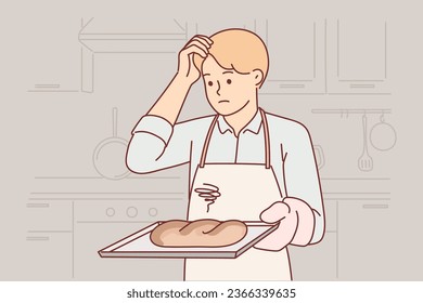 Confused baker holds tray with spoiled bread, burnt due to non-compliance with cooking technology, stands in kitchen. Sad clumsy baker needs refresher course or professional education