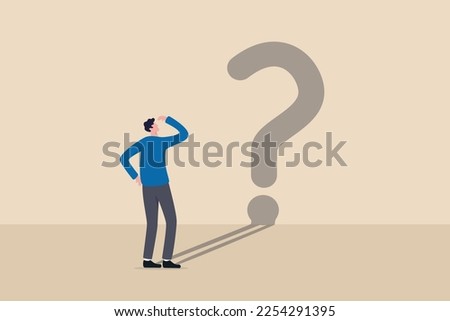 Confusion, uncertainty or self doubt, finding meaning in live, question to answer or searching solution to solve problem concept, curios businessman looking at self shadow as question mark sign.