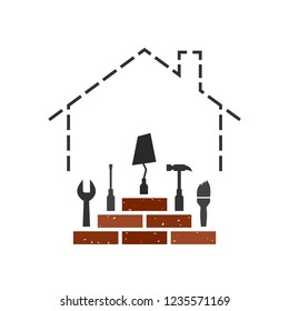 Construction concept with house outline made of dotted line. Bricks and tools on top: wrench, screwdriver, bricklayer's trowel, hammer and paint brush.