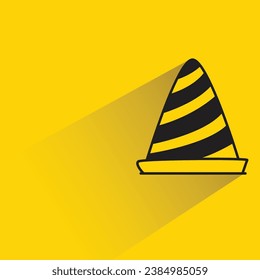 construction cone with shadow on yellow background