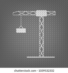 Construction crane sign. Vector. White knitted icon on gray knitted background. Isolated.