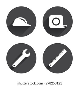 Construction helmet and wrench key tool icons. Ruler and tape measure roulette sign symbols. Circles buttons with long flat shadow. Vector