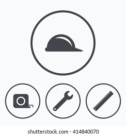 Construction helmet and wrench key tool icons. Ruler and tape measure  sign symbols. Icons in circles.