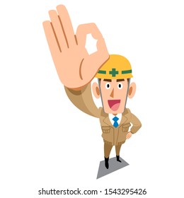 Construction site worker wearing beige work clothes showing OK sign by hand