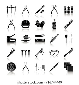 Construction tools drop shadow black glyph icons set. Renovation and repair instruments. Emery paper, solderer, ratchet, bearing puller, spirit level. Isolated vector illustrations