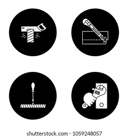 Construction tools glyph icons set. Tenon saw, stationery knife, screwdriver, wrench in hand. Vector white silhouettes illustrations in black circles