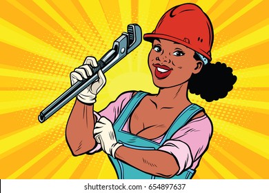 Construction worker with adjustable wrench. Woman professional