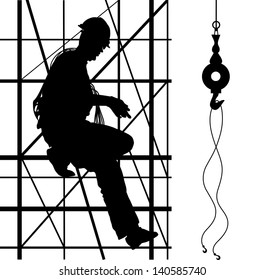 Construction worker is climbing on metal scaffolding. Silhouette.