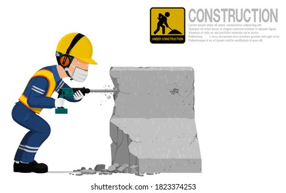 A construction worker is using jack hammer  for demolishing the concrete barrier.
