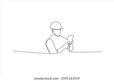 Construction worker using a tablet on-site, focused on task amidst a minimal background