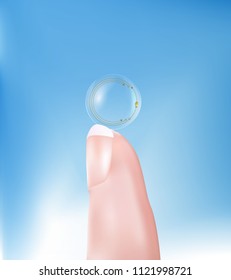 Contact lens with high-tech chip held between  fingers. Technology of the future