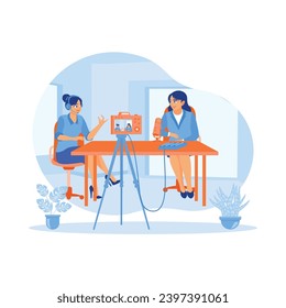 Content creator interviews female vloggers in a home studio. Record vlogs using a digital camera and broadcast live on social media. Content Creator concept. Trend Modern vector flat illustration