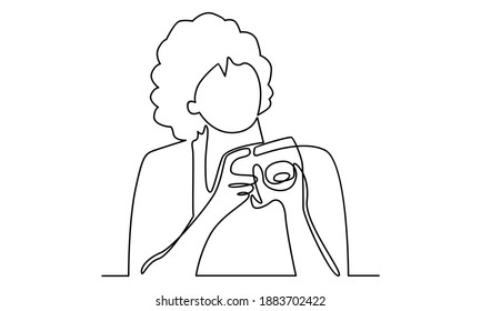 Continue line of woman holding digital camera