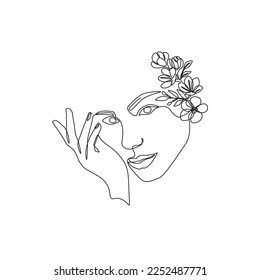 Continuous line drawing of Beautiful Woman's face with flowers. Nature cosmetics. The Concept of Skin Beauty Care for young female models. Bouquet of flowers in one line artwork of woman's head.