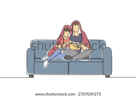 Continuous line drawing of a couple snuggled under a blanket on a couch, sharing popcorn and watching a movie, symbolizing intimate home entertainment. Celebrating National Movie Night event