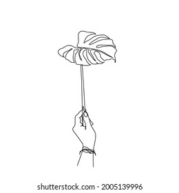 continuous line drawing of hand holding monstera leaf. Tropical leaf lineart with active stroke. 