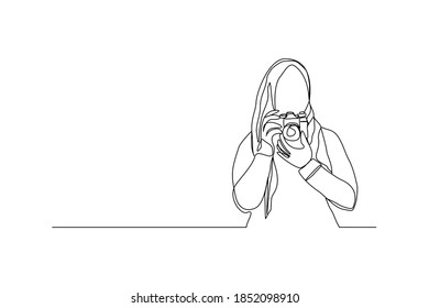 Continuous line drawing of professional woman muslim hijab photographer take picture use camera. One line art concept of photography. Vector illustration