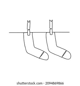 Continuous line drawing socks hanging on the clothesline. Socks hanging on the clothesline one line illustration for print, web, mobile and infographics. Vector illustration.