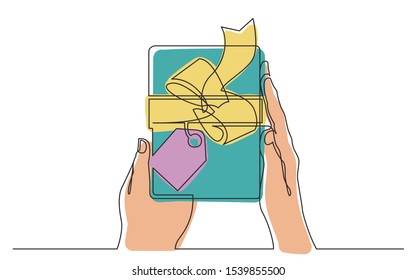 continuous line drawing of two hands holding gift box with ribbon and label