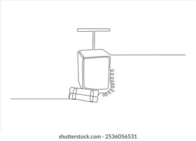 Um desenho de linha contínua de um telefone vintage com um cabo e dinamite varas nas proximidades.