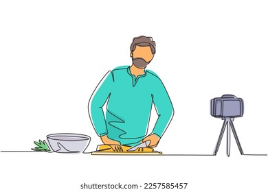 Continuous one line drawing Arabian chef standing in kitchen and cutting onion while filming himself for blog. On kitchen counter are vegetables and spices. Single line draw design vector illustration