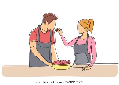 Continuous one line drawing beautiful wife feeds her husband food   in front him is bowl filled and salad  Cooking together in cozy kitchen  Single line draw design vector graphic illustration