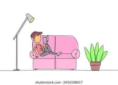 Continuous one line drawing boy sitting stretched out on the sofa reading a book. Really like the content of the book reading on each page. Impressive. Single line draw design vector illustration