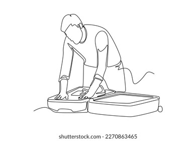 Continuous one line drawing  businessman packing his clothes in an opened suitcase. Travel experience concept. Single line draw design vector graphic illustration.