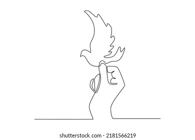 Continuous one line drawing dove in hand. Peace day concept. Single line draw design vector graphic illustration.