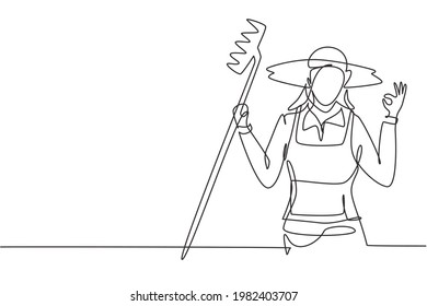 Continuous one line drawing female farmer with gesture okay wearing straw hat and carrying rake to work on the farm. Success business concept. Single line draw design vector graphic illustration