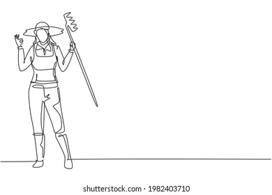 Una línea contínua que dibujaba a una agricultora estaba de acuerdo con el gesto, usando sombrero de paja y llevando rastrillo para plantar cultivos en tierras de cultivo. El negocio del éxito. ilustración vectorial de diseño de línea única