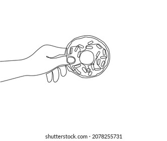 Continuous one line drawing female hand holding donuts. Chocolate donut with frosting, sweet product with sprinkles. Baked pastry with cream or sugar based. Single line draw design vector illustration