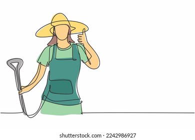 Continuous one line drawing female farmer with a thumbs-up gesture wearing a straw hat and carrying a shovel to work on the farm at harvest time. Single line draw design vector graphic illustration.