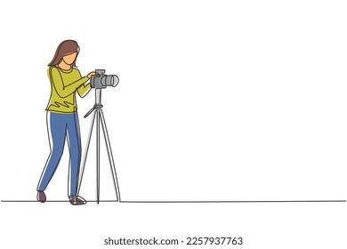 Continuous one line drawing female photographer taking photos using professional equipment set. Woman with camera making pictures. Studio photo equipment. Single line draw design vector illustration