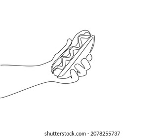 Continuous one line drawing hand holding hotdog. Street junk food. American meal. Hand holding bun, sausage. Bite and snack. For restaurant or cafe drink menu. Single line draw design vector graphic