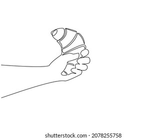 Continuous one line drawing hand holding fresh baked croissant. Hands holding croissant bagel bun. Traditional breakfast. For restaurant or cafe drink menu. Single line draw design vector graphic