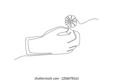 Continuous one line drawing hand holding pin flower poppy. Remembrance day concept. Single line draw design vector graphic illustration.