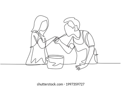 Continuous one line drawing 
happy husband tasting food given by his young beautiful wife. Cooking for lunch together in cozy kitchen at home. Single line draw design vector graphic illustration